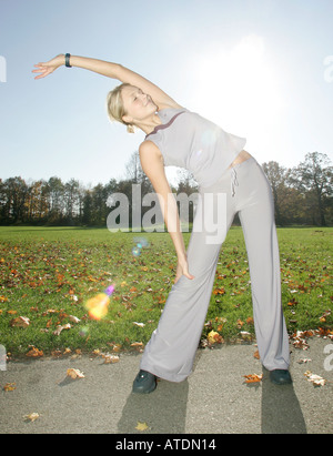 young woman doing stretching exercises in the park Stock Photo