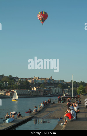 Bristol hot air balloon gliding over Baltic Wharf area with sailing dinghies on the Floating Harbour Stock Photo