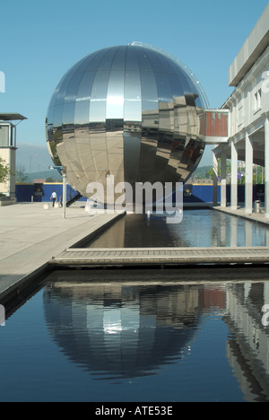 Bristol chrome plated sphere housing the planetarium The Orange Imaginarium in Millennium Square reflected in water feature Stock Photo