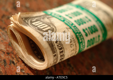 a roll of ten One Hundred dollar bills totaling US $1000 Stock Photo