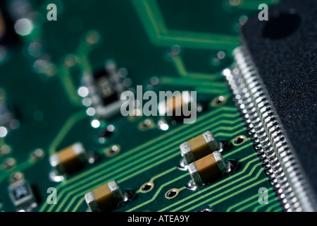 Detail of an integrated circuit board showing the etched connections between components. Stock Photo