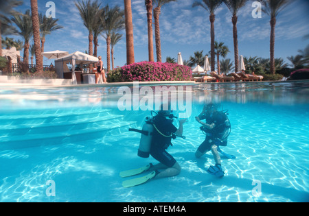 Scuba diving lessons swimming pool Sharm el Sheikh Egypt Red Sea split level Stock Photo