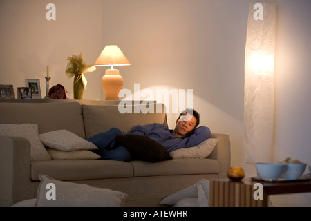 Young man sleeping on a couch Stock Photo