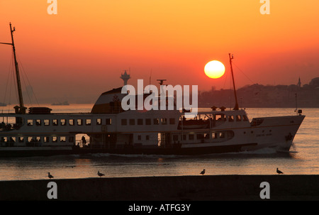 A Bosphorous ferry making the crossing from Asia to Europe at sunset Stock Photo