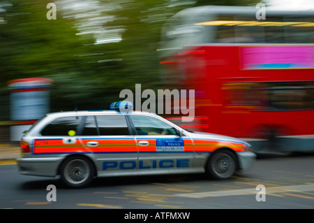 Police car rushing along Bayswater Road in London England UK Stock Photo