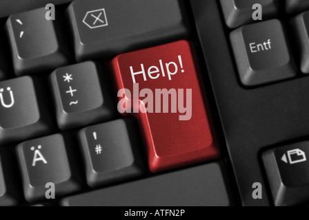 Close up of a computer keyboard with a red key showing help Stock Photo