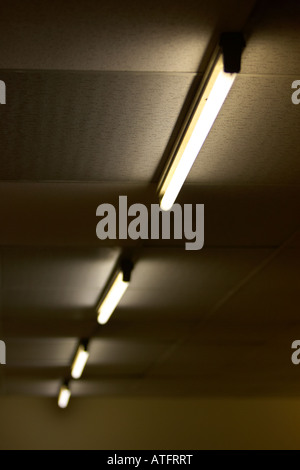 row of flourescent striplights attached to a false ceiling Stock Photo