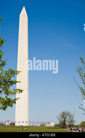 Half Mast at Washington Monument. Tourists mingle with flags at half mast in honour of the 2007 Virginia Tech massacre Stock Photo