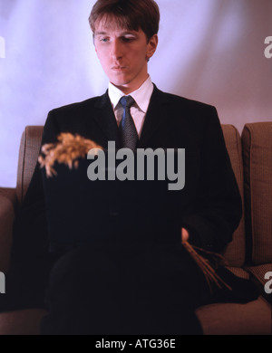 Man in suit with laptop and bouquet Stock Photo