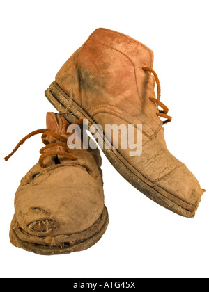 Old worn out working boots with holes Stock Photo