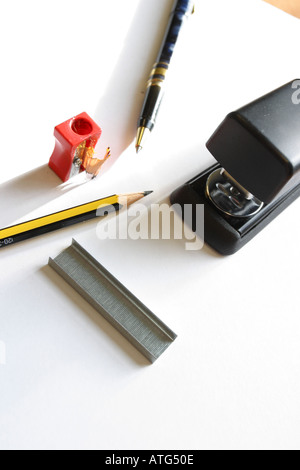 Basic essential office equipment pen pencil sharpener stapler staples Stock Photo