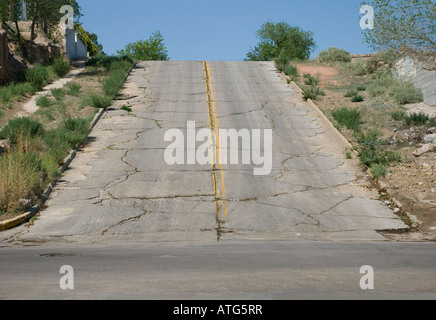 Cracked asphalt road in Gallup, New Mexico, USA Stock Photo
