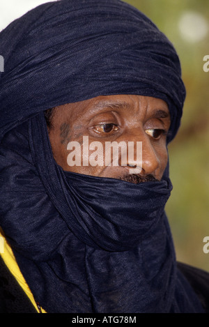 Portrait of a Tuareg man with a turban covering the lower part of his ...