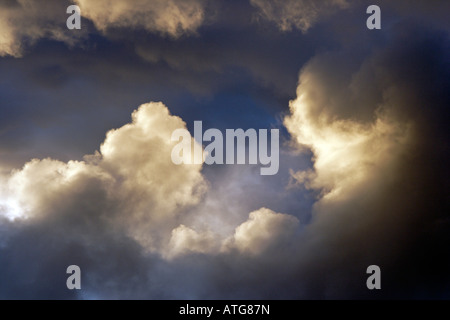 Dramatic clouds in the evening light Stock Photo