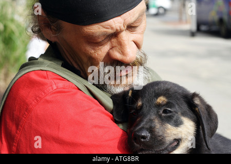 Elderly man holding a puppy Stock Photo