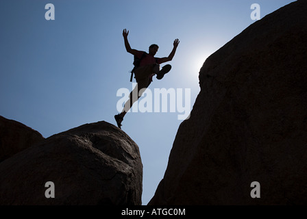 Man jumping chasm Stock Photo