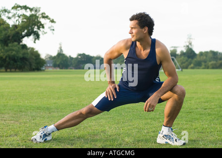 Man stretching in park Stock Photo