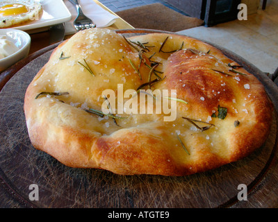 Italian Focaccia bread with rosemarin herb and large grains of salt Stock Photo
