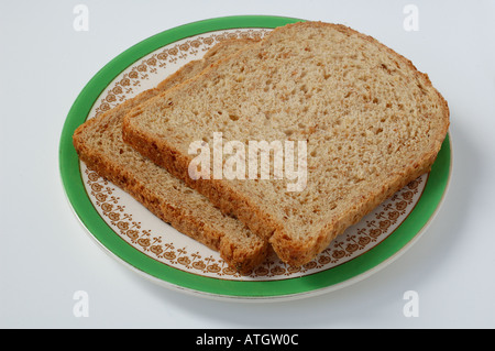 Slice of brown bread on old fashioned plate Stock Photo