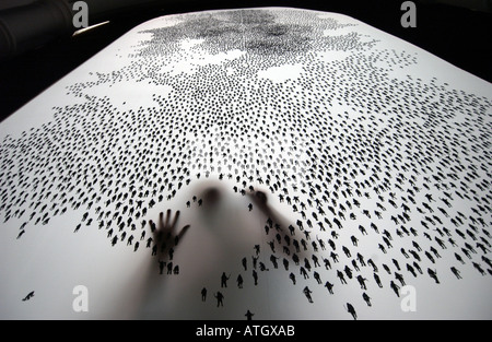 Artist painstakingly draws ten thousand tiny human figures on a screen Stock Photo