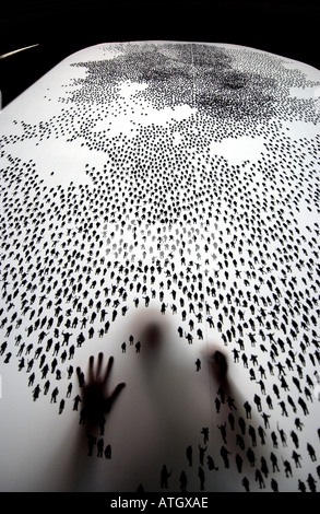 Artist painstakingly draws ten thousand tiny human figures on a screen at Fabrica Art Gallery Brighton UK Stock Photo