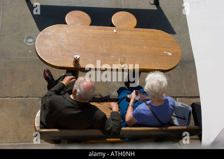 View from above of couple having a pause for a drink in the sunshine Stock Photo