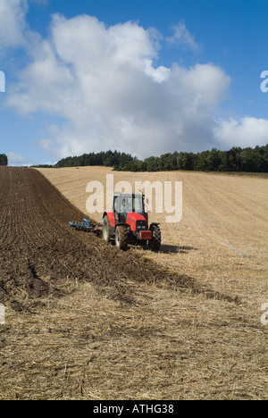dh Massey Ferguson tractor PLOUGHING PERTHSHIRE Red tractors ploughing field of stubble Scotland farm uk farming agriculture in land scottish farmland Stock Photo