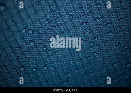 photo showing rain drops on the outside of tent canvas with stitching patterns Stock Photo