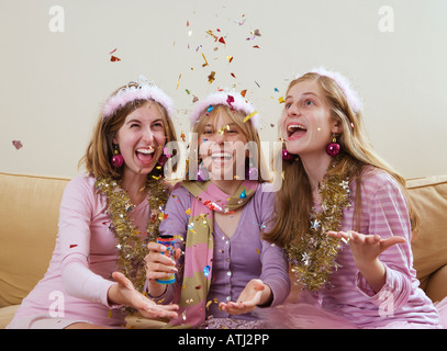 three teenage girls popping party popper Stock Photo