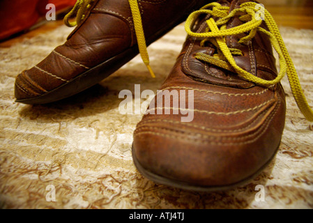 old brown skin shoes with yellow cords Stock Photo