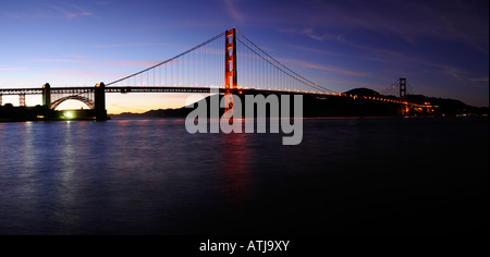 High resolution stitched image of glowing Golden Gate bridge and Fort Point at sunset First stars can be seen in the sky Stock Photo