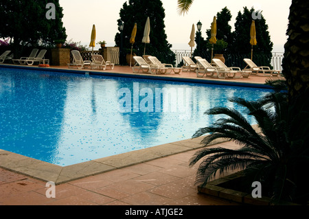 Raindrops falling on the surface of a swimming pool Stock Photo