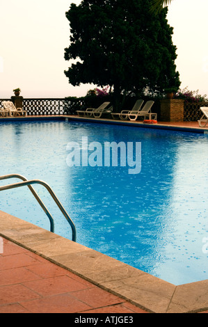 Raindrops falling on the surface of a swimming pool Stock Photo