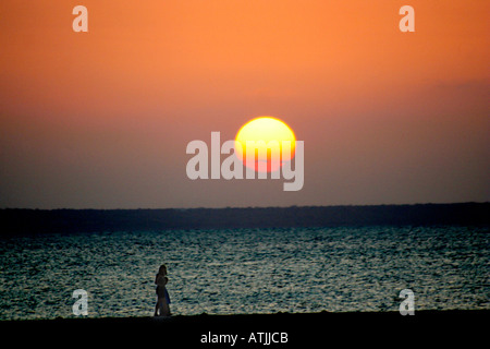 Africa Mozambique sunset over couple walking on Benguerra Island Stock Photo