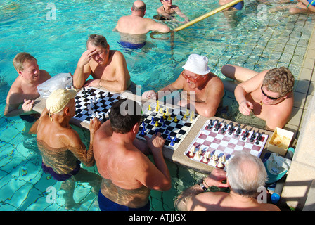 Men playing chess in outdoor thermal pool, Szechenyi Baths, Varosliget, Pest, Budapest, Republic of Hungary Stock Photo