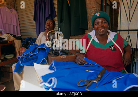 Seamstress at work on pavement, Soweto, South Africa Stock Photo
