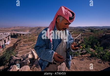 A Bedouin man using a cell phone Stock Photo