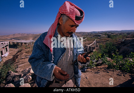 A Bedouin man using a cell phone Stock Photo