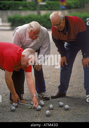 Elderly gentlemen or senior citizens playing boules in town or city parks across Europe Stock Photo