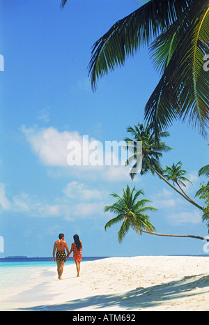 Couple on white sandy beach in South Male Atoll of Maldive Islands Stock Photo