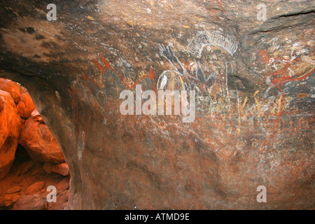 Sunlight enters a cave with Aboriginal cave paintings at the bottom of Ayers rock Uluru popular Australian tourist destination Stock Photo