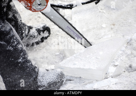 Cutting ice blocks with a chainsaw Stock Photo