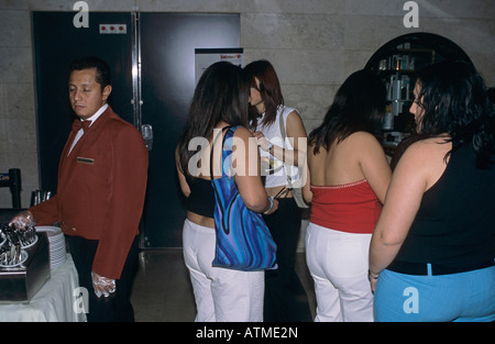 fat girls and sleepy waiter at the midnight buffet on board a cruise ship Stock Photo