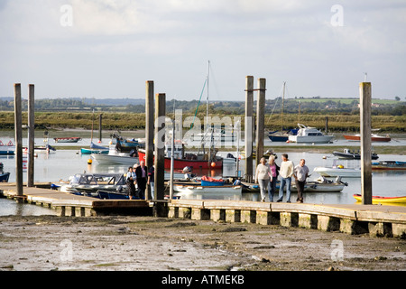 VISITORS TO WEST MERSEA NEAR COLCHESTER ESSEX WALK ALONG THE PONTOON Stock Photo