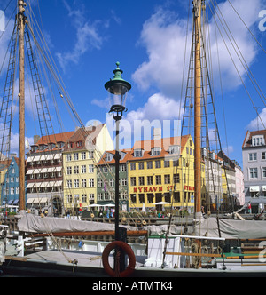 Moored sailboats and Nyhavn 17 cafe, Nyhavn, Copenhagen, Denmark Stock Photo