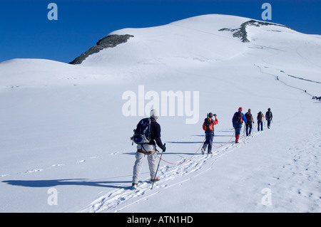 mountaineers hiking over a glacier towards Breithorn 4164 m Zermatt Wallis Valais Switzerland Stock Photo