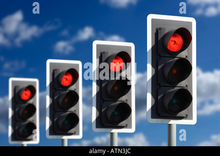 ROW OF FOUR ROAD TRAFFIC LIGHTS SHOWING RED Stock Photo