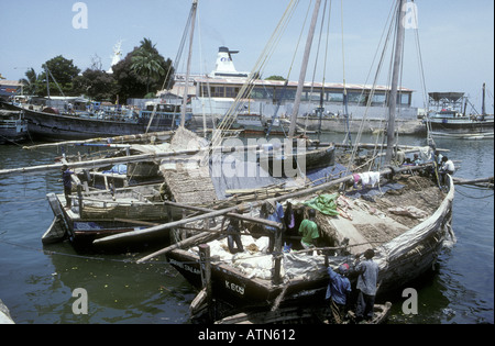 Two dhows or sailing boats loaded up in Zanzibar harbour Tanzania East Africa Stock Photo