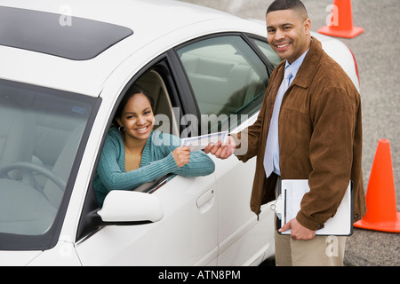 African teenager receiving drivers test certificate Stock Photo