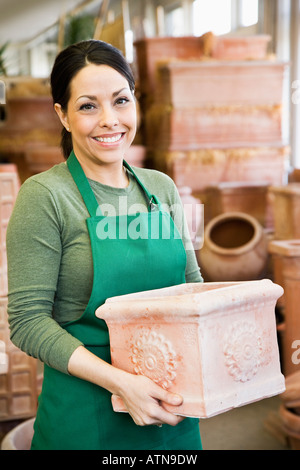 Hispanic woman working at garden center Stock Photo
